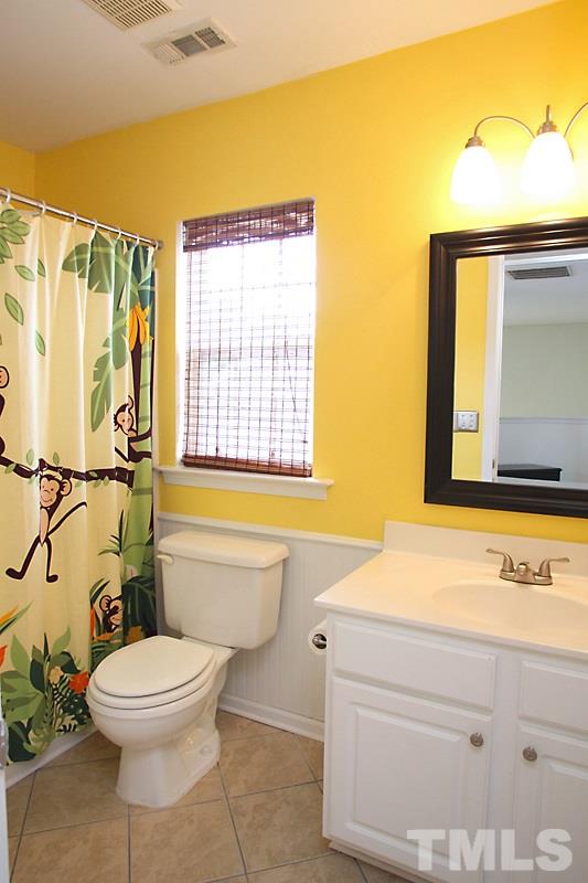 4717 Delta Ridge Court Raleigh, NC 27612 - Photo 20 of 25 Hall bath with tile floor and beadboard.