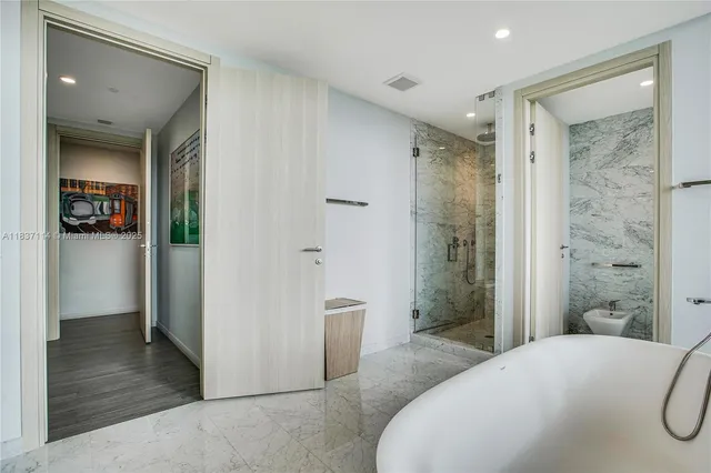 a spacious bathroom with a shower and a mirror