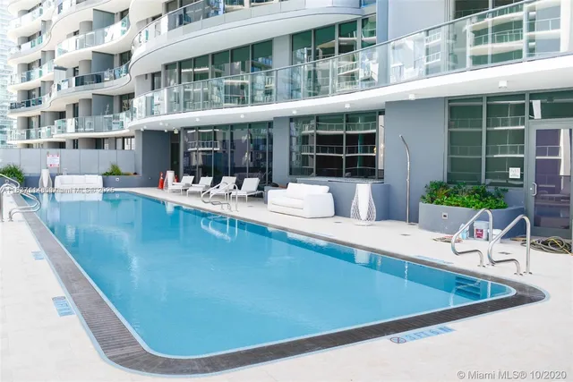 a view of a swimming pool with lounge chair