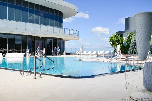 a view of a swimming pool with a table and chairs