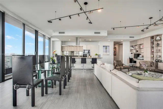 a large kitchen with a table and chairs