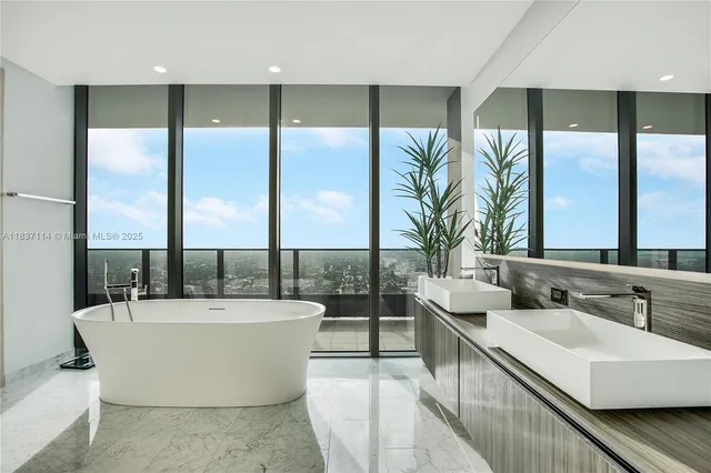 a view of a bathroom with a tub and sink