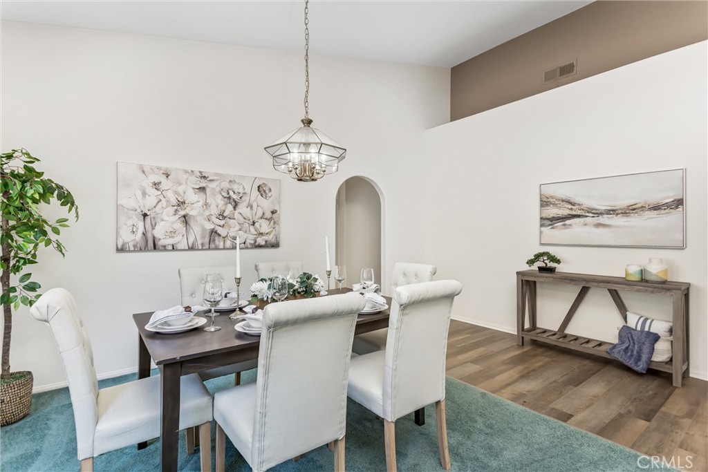 8742 Feathertop Road Riverside, CA 92508 - Photo 13 of 40 The formal dining room! Soaring vaulted ceilings, architectural display ledges, and abundant natural light give this single-story Orangecrest home an open, spacious feel that is both welcoming and elegant. Note the arched entrance to the kitchen! The hard floors are Brand new!