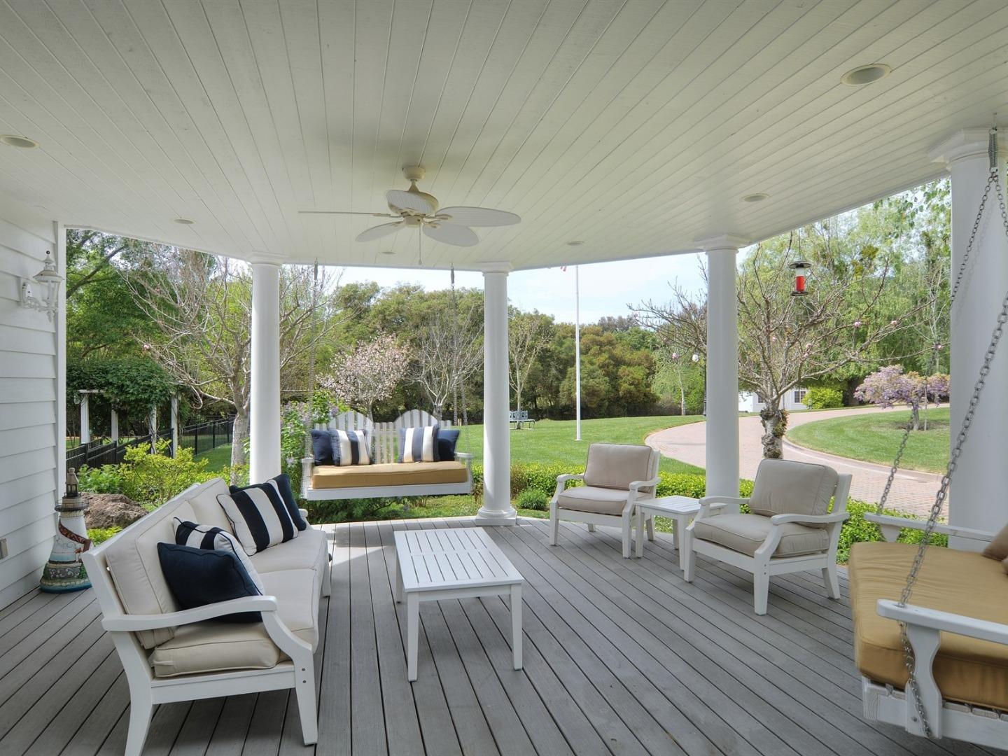 10035 Burchell Road Gilroy, CA 95020 - Photo 12 of 55 a view of a patio with lawn chairs and a floor to ceiling window