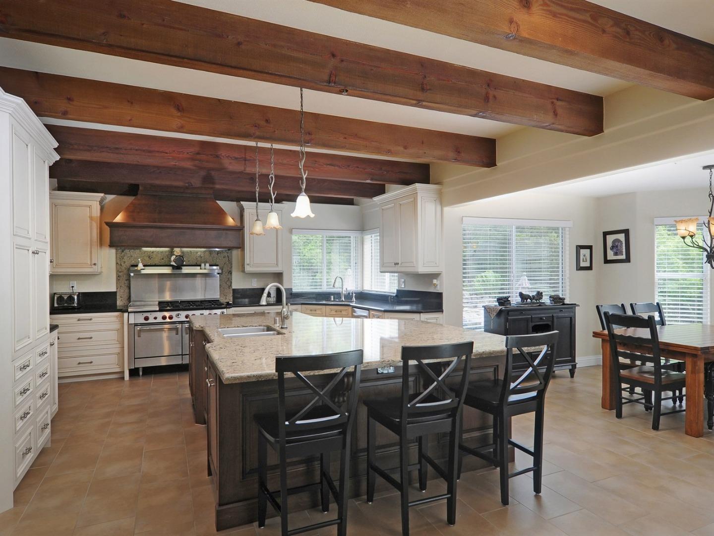 10035 Burchell Road Gilroy, CA 95020 - Photo 15 of 55 a dining hall with stainless steel appliances kitchen island granite countertop a table and chairs in it