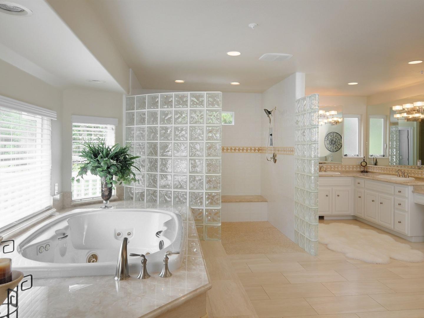10035 Burchell Road Gilroy, CA 95020 - Photo 21 of 55 a bathroom with a tub a sink and a large mirror