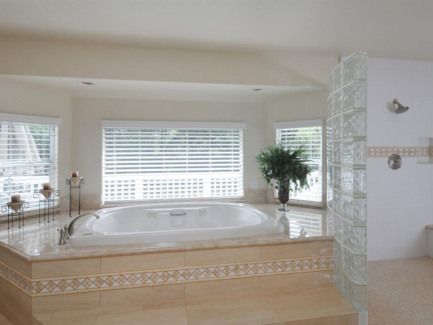 10035 Burchell Road Gilroy, CA 95020 - Photo 23 of 55 a bath tub sitting in a bathroom next to a window