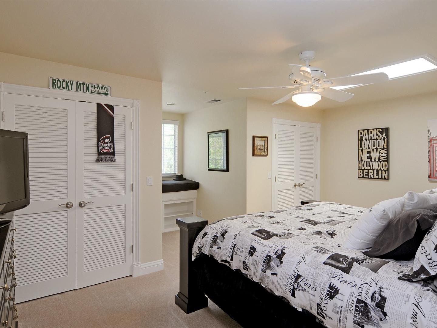 10035 Burchell Road Gilroy, CA 95020 - Photo 24 of 55 a bedroom with a large bed and a chandelier