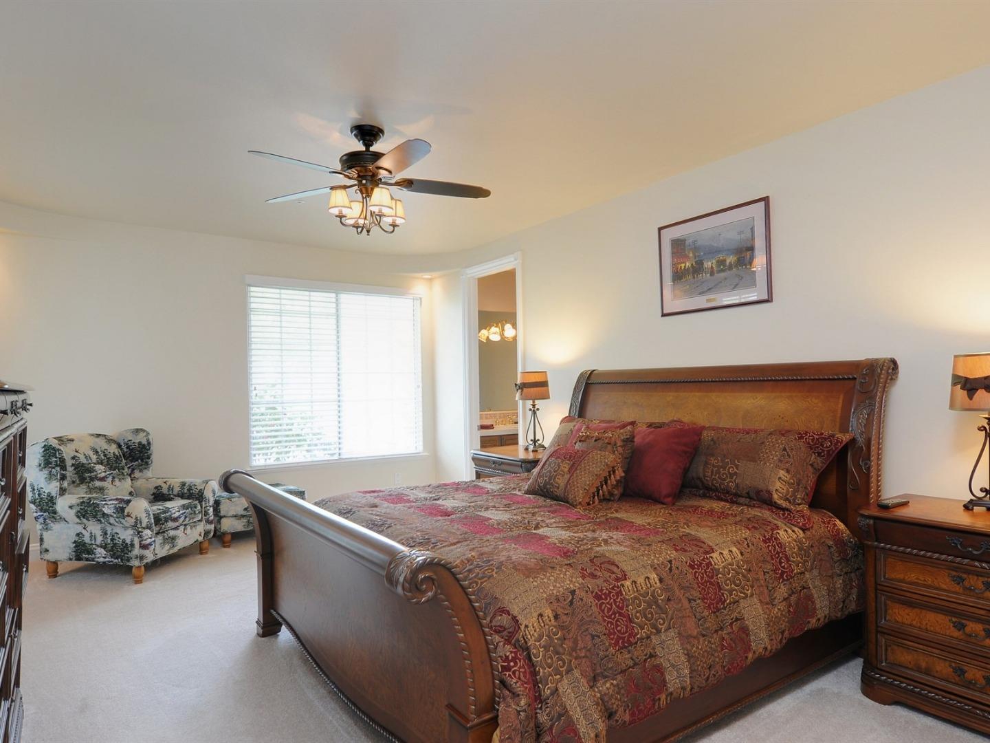 10035 Burchell Road Gilroy, CA 95020 - Photo 27 of 55 a bedroom with a bed and a chandelier