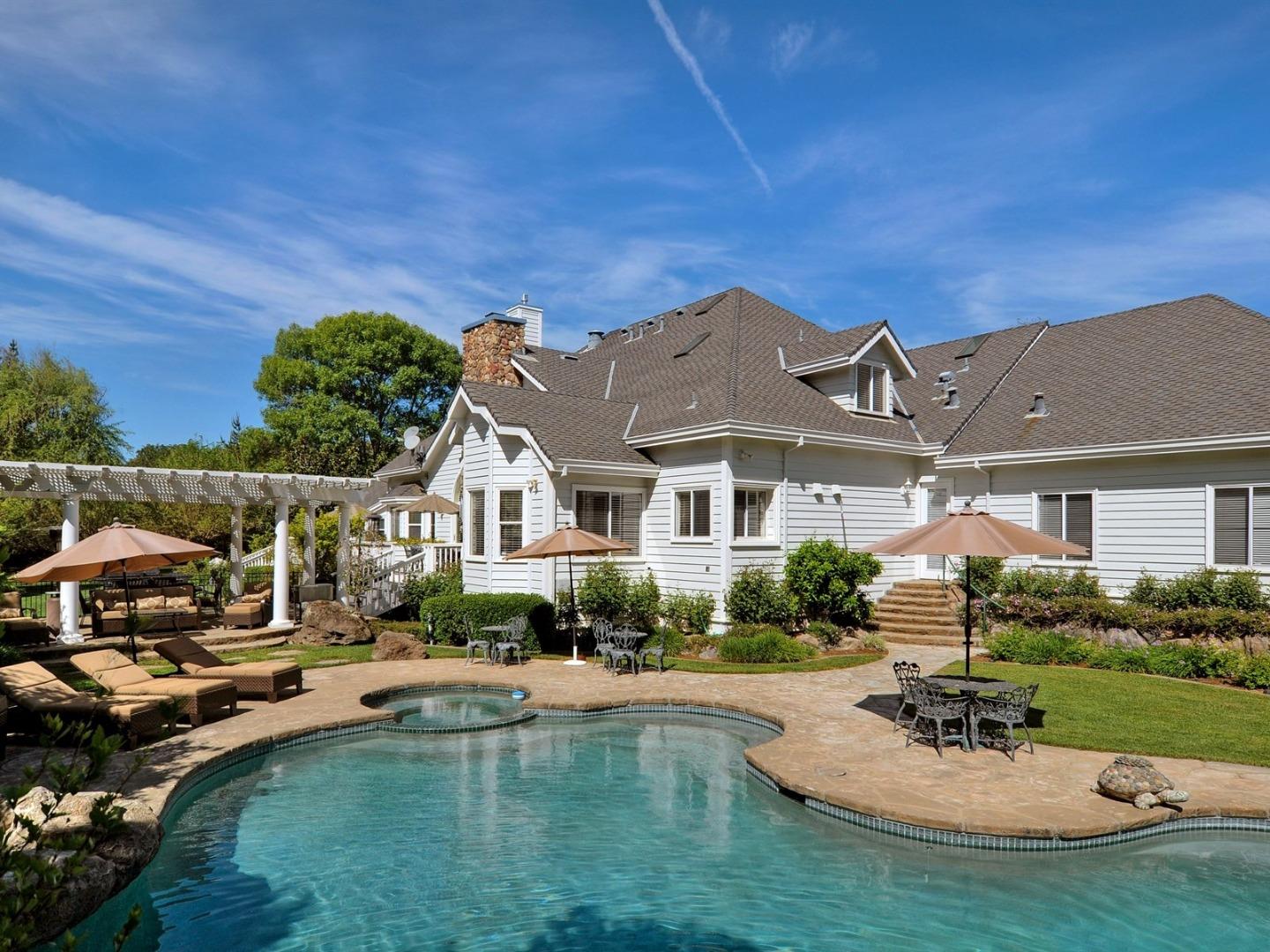 10035 Burchell Road Gilroy, CA 95020 - Photo 39 of 55 a front view of a house with swimming pool having outdoor seating