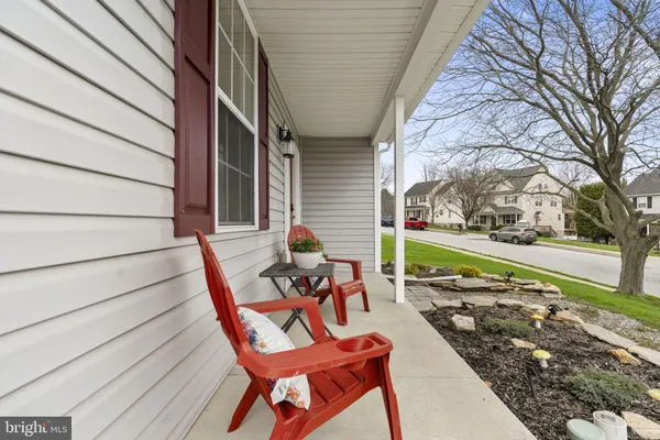 a balcony with chairs and wooden floor