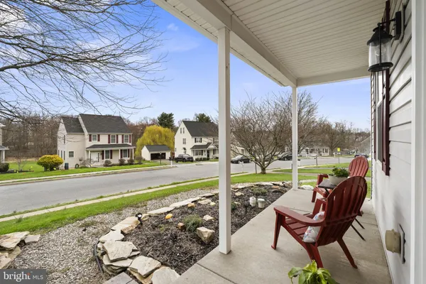 a view of a chair and tables in the patio next to a yard