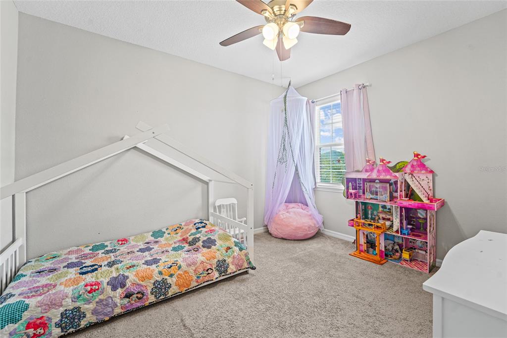 8903 Arabella Lane Seminole, FL 33777 - Photo 33 of 47 a bedroom with bed and a chandelier