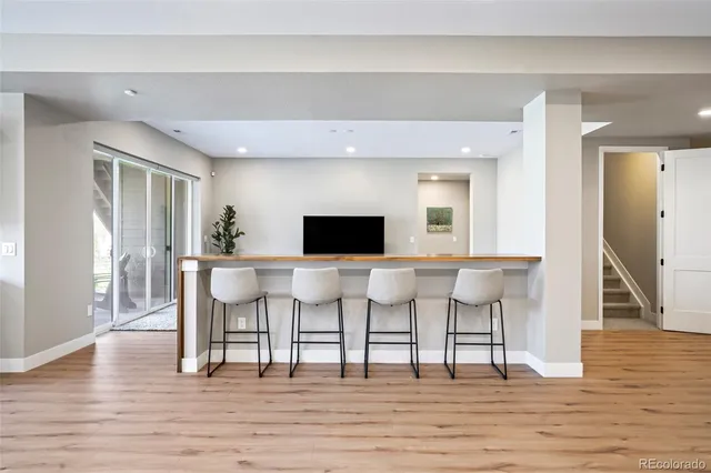 a living room with furniture wooden floor and a rug