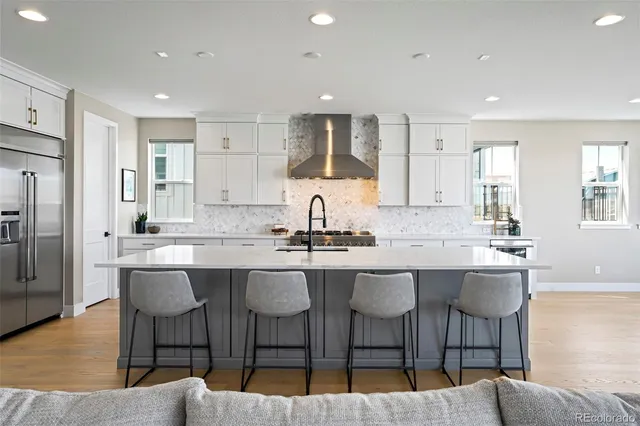a kitchen with center island table and chairs in it