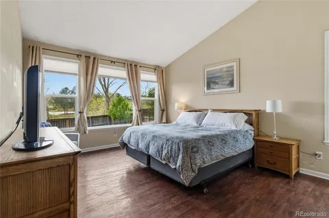 a bedroom with a bed and a night stand