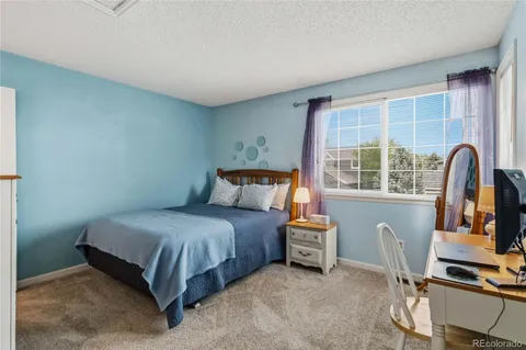 a bedroom with a bed and a flat tv screen