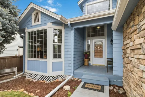 a view of a house with a yard porch and sitting area