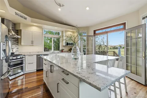 a kitchen with granite countertop a stove and a sink