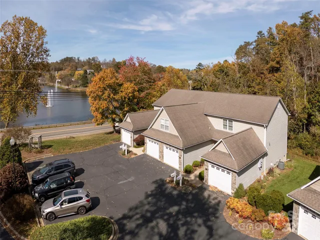 an aerial view of a house with yard swimming pool and outdoor seating