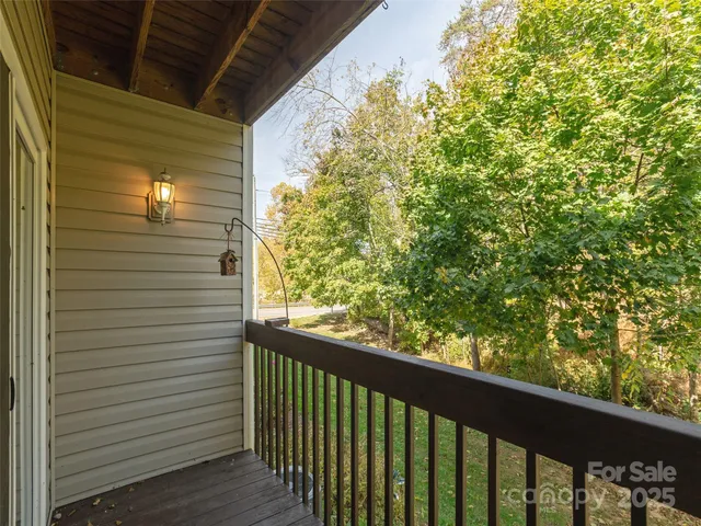 a view of a balcony with tree