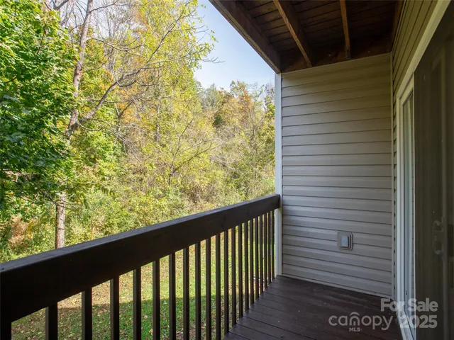 a view of a balcony with wooden fence