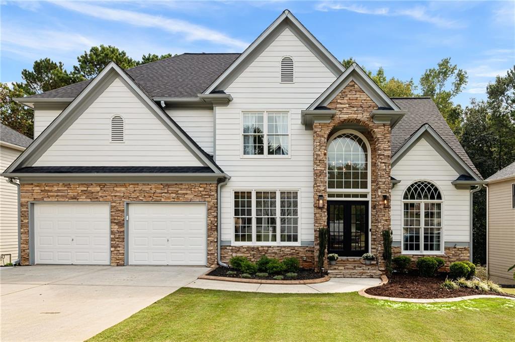 112 Gold Mill Place Canton, GA 30114 - Photo 1 of 1 a front view of a house with yard and parking
