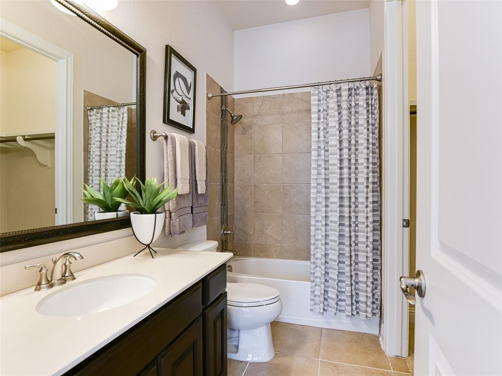2657 Montebelluna Place Leander, TX 78641 - Photo 11 of 29 a bathroom with a sink a toilet a shower and a mirror