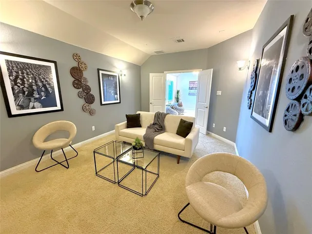 a living room with furniture and a painting