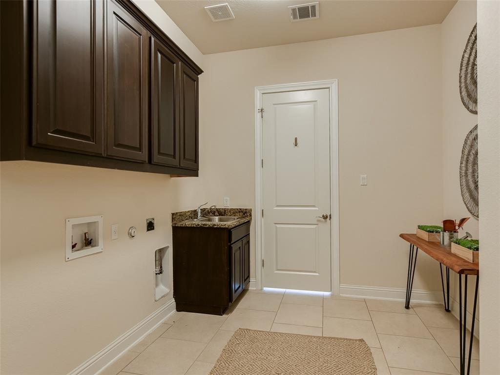 2657 Montebelluna Place Leander, TX 78641 - Photo 21 of 29 Washroom featuring hookup for a gas dryer, light tile patterned floors, washer hookup, cabinet space, and hookup for an electric dryer
