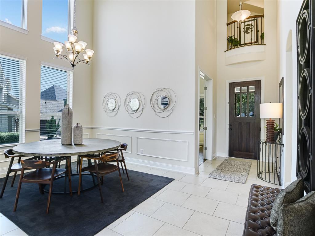 2657 Montebelluna Place Leander, TX 78641 - Photo 3 of 29 Foyer featuring a decorative wall, light tile patterned floors, wainscoting, a high ceiling, and a chandelier