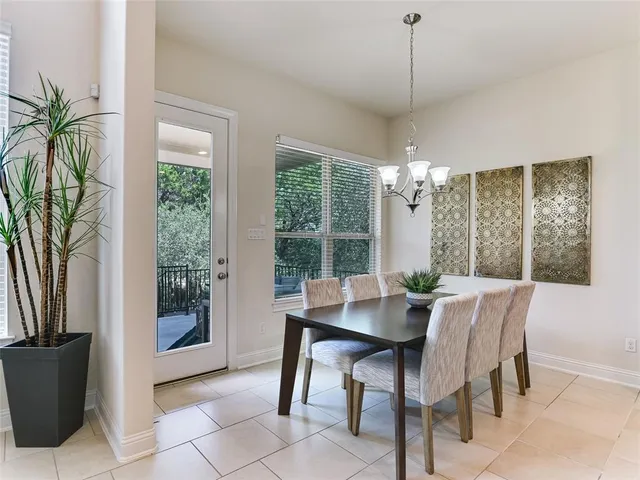 a dining room with furniture a chandelier and window