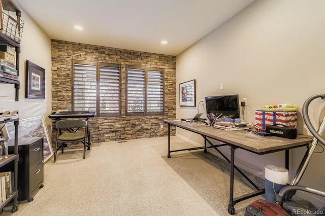 a bathroom with a granite countertop toilet sink and mirror