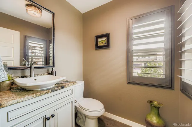 a view of a hallway with closet and wooden floor