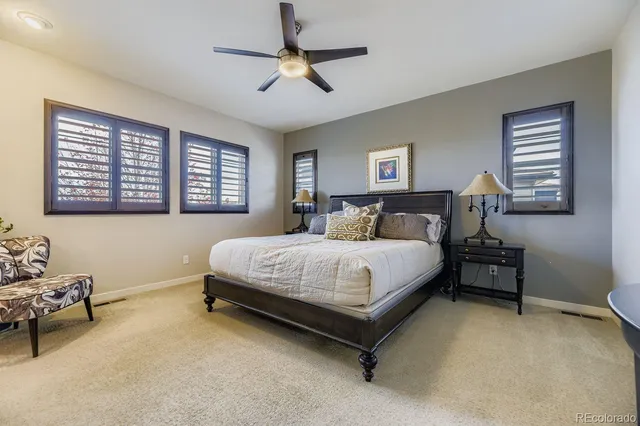 a bedroom with a bed and paintings on the wall