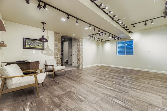 a bathroom with a granite countertop sink a toilet and mirror