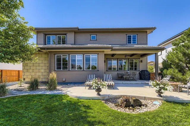 a view of a patio with chairs and potted plants