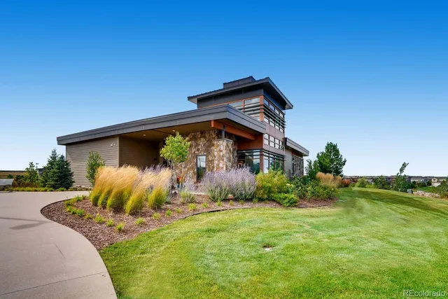 a view of a house with a big yard and sitting area