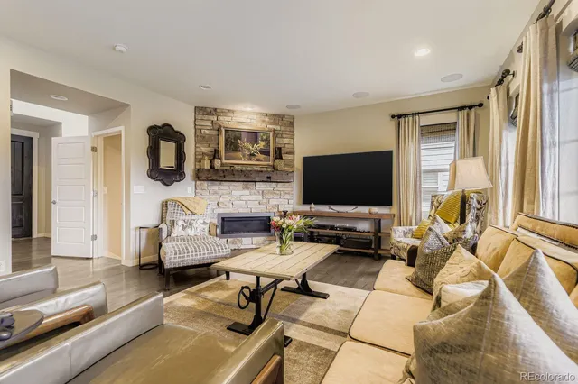 a living room with furniture and a fireplace