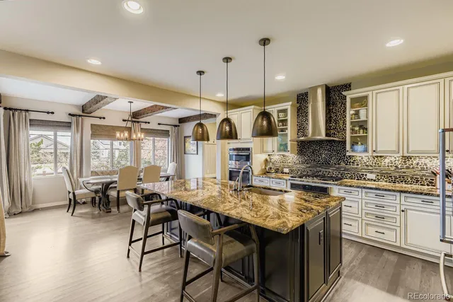 a kitchen with stainless steel appliances granite countertop a stove and refrigerator