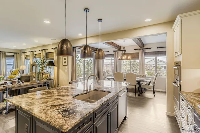 a dining room with furniture a chandelier and wooden floor