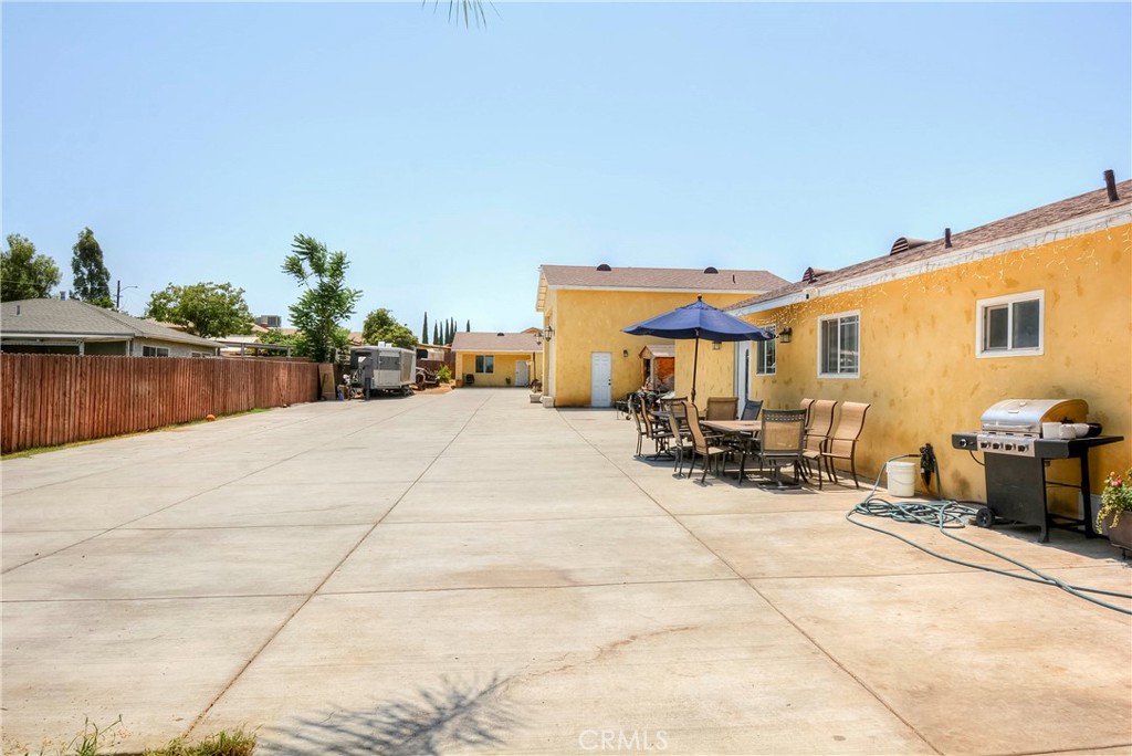 4320 Ambs Drive Riverside, CA 92505 - Photo 2 of 35 a view of a patio with table and chairs potted plants with wooden fence