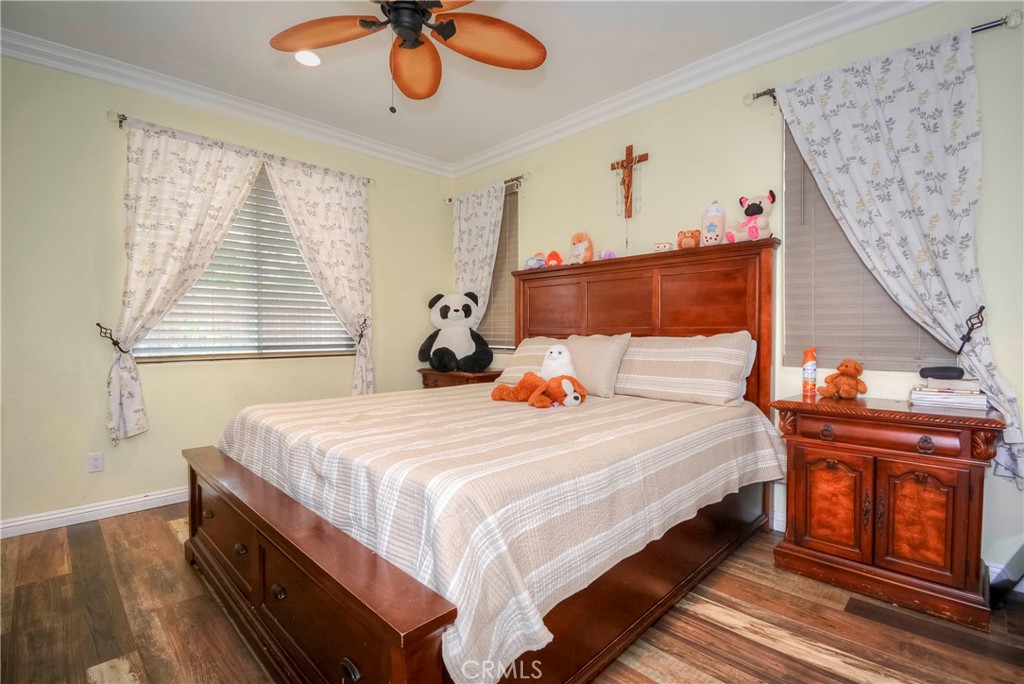 4320 Ambs Drive Riverside, CA 92505 - Photo 25 of 35 a bedroom with a bed and a chandelier