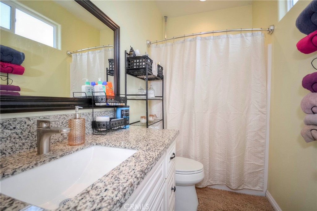 4320 Ambs Drive Riverside, CA 92505 - Photo 26 of 35 a bathroom with a granite countertop sink toilet and shower