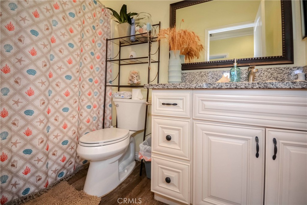 4320 Ambs Drive Riverside, CA 92505 - Photo 32 of 35 a bathroom with a granite countertop sink and a toilet