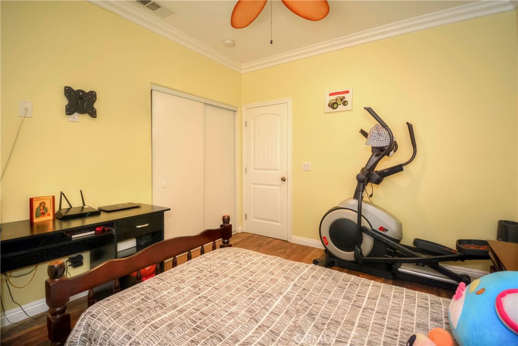 4320 Ambs Drive Riverside, CA 92505 - Photo 33 of 35 a bedroom with a bed and gym equipment