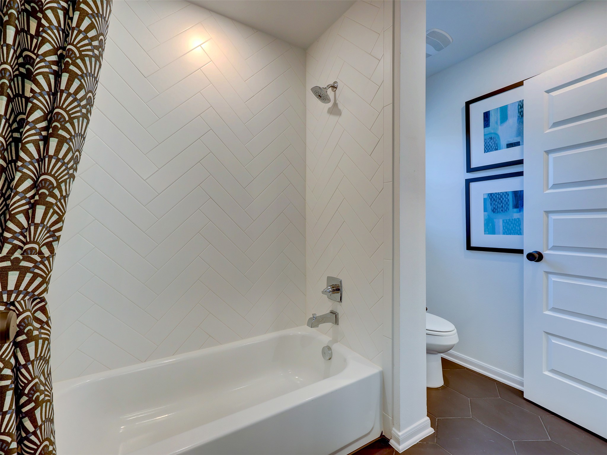 6220 Bower Well Road Austin, TX 78738 - Photo 25 of 28 White subway tile with a chevron pattern creates a chic backdrop for this bathroom's tub and shower.