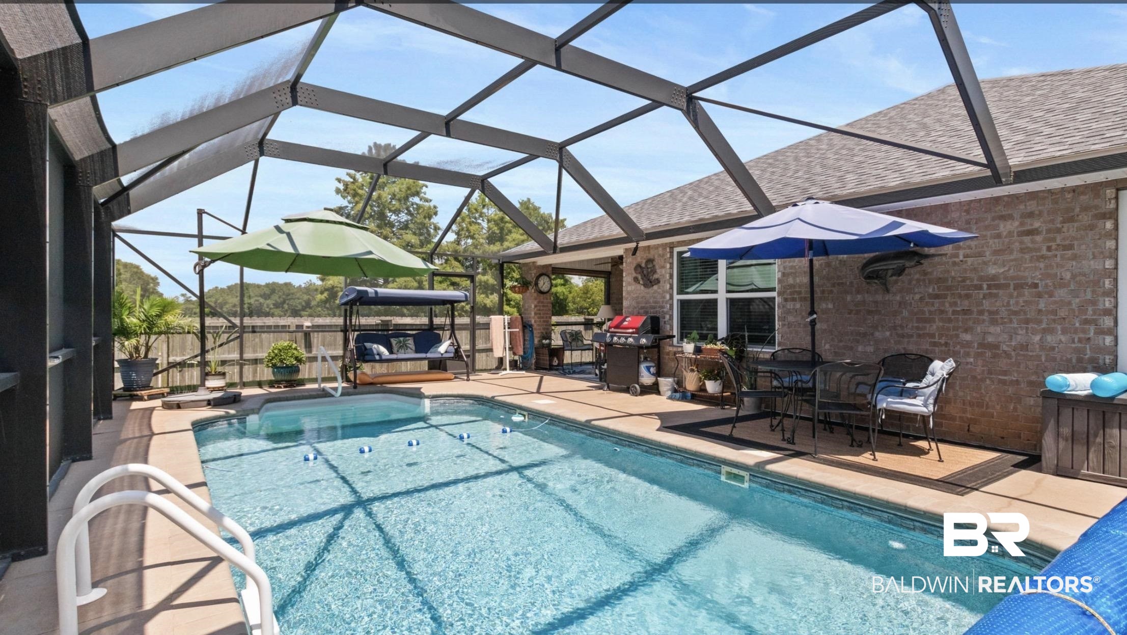 1676 Abbey Loop Foley, AL 36535 - Photo 11 of 31 Screened-in swimming pool with an integrated spa, surrounded by a concrete deck