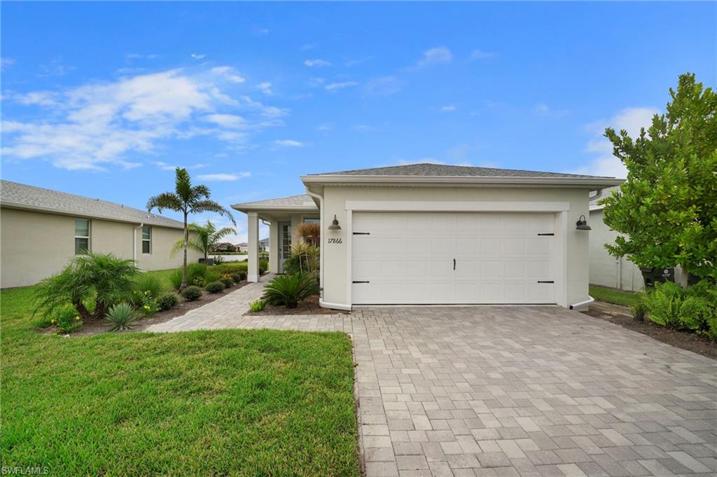 a front view of a house with a yard and garage