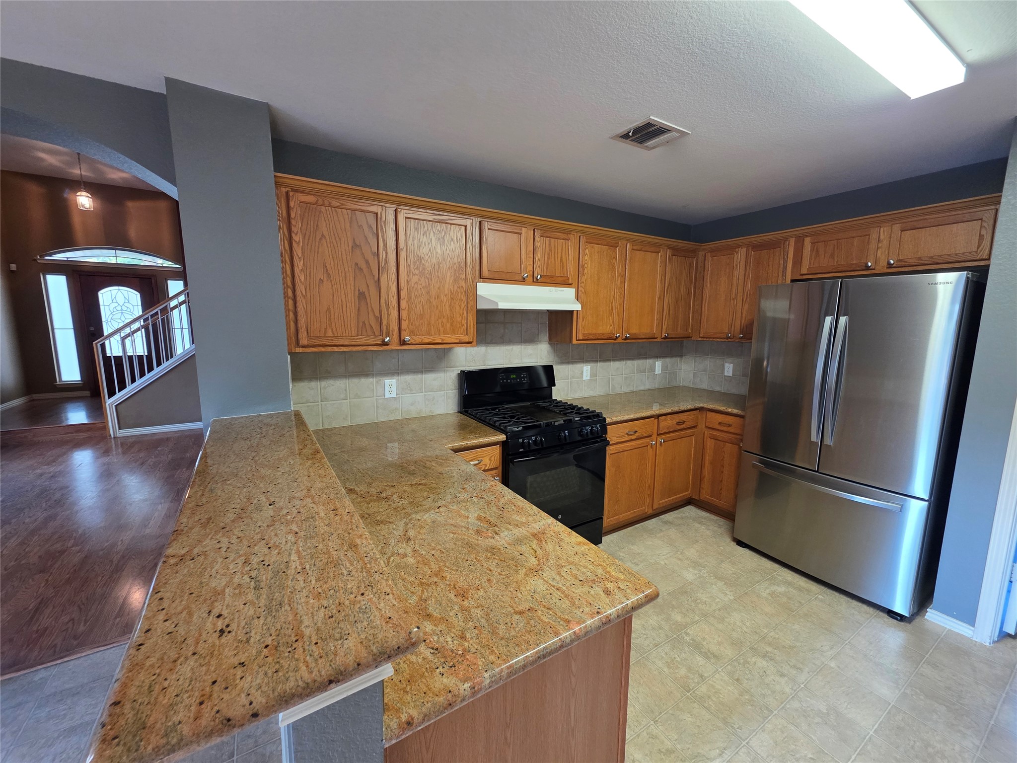 2210 Wilma Rudolph Road Austin, TX 78748 - Photo 5 of 20 Gleaming granite countertops pair beautifully with classic oak cabinetry in this functional kitchen.